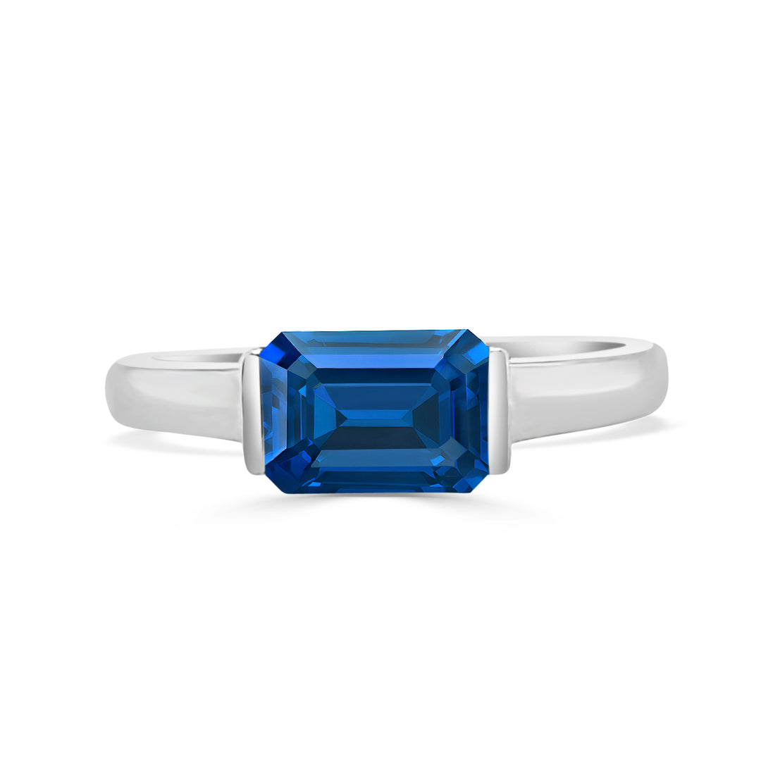 14K White Gold Half Bezel Emerald Cut Blue Topaz Ring (1.23 ct)